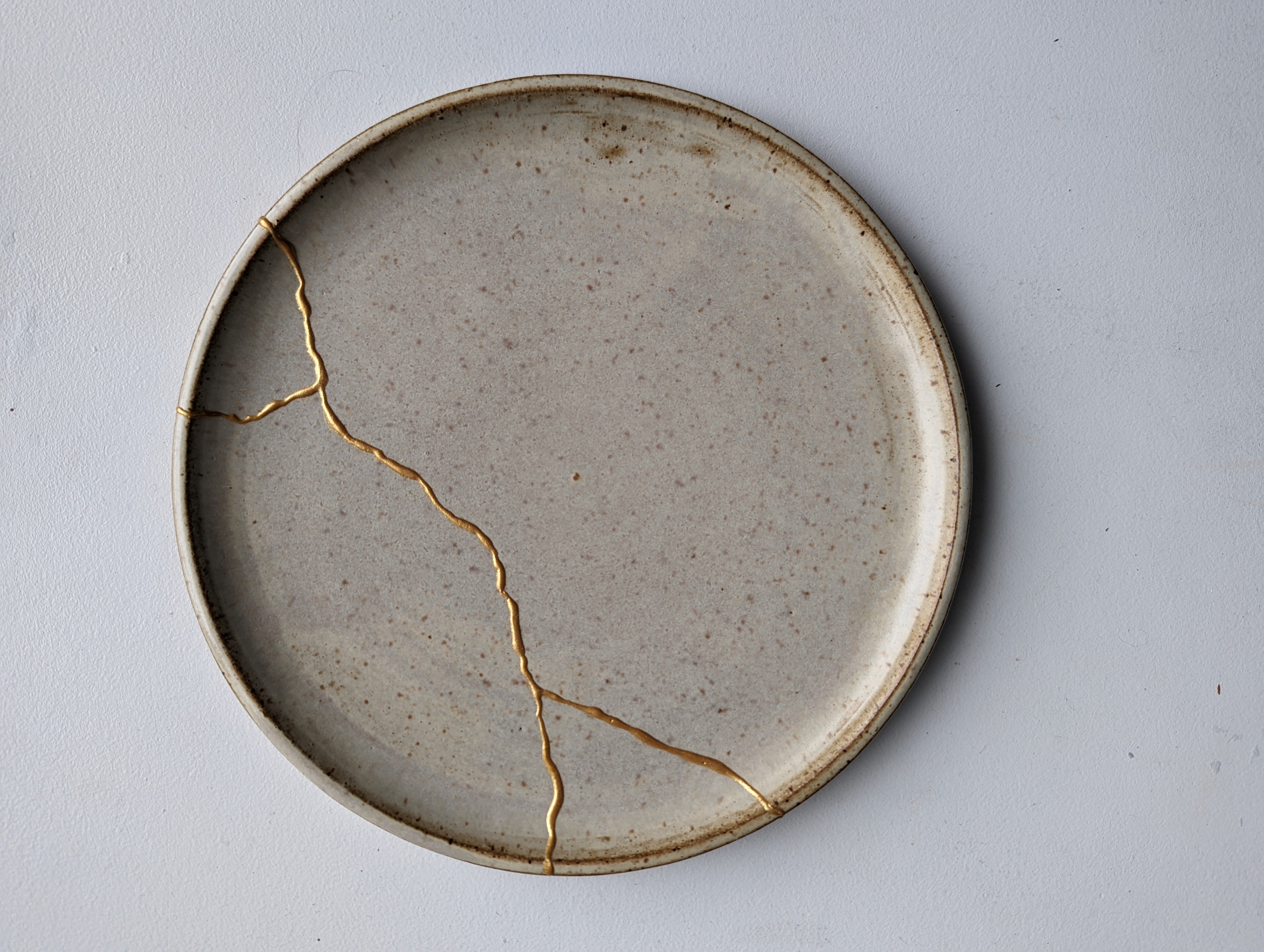 ceramic plate repaired using mended with gold kintsugi repair kit